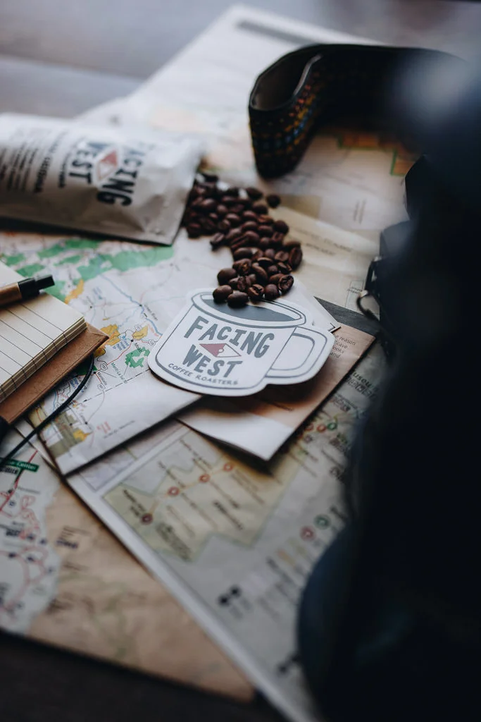 Whole bean coffee on the table with maps