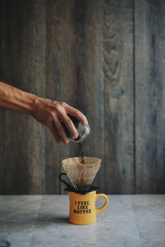Adding ground coffee to v60 pour over