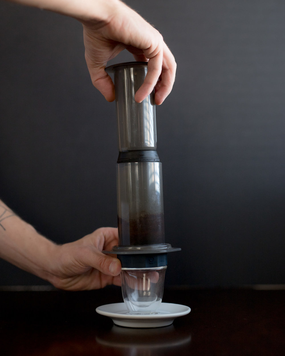 Brace the cup and bottom of the Aeropress with one hand