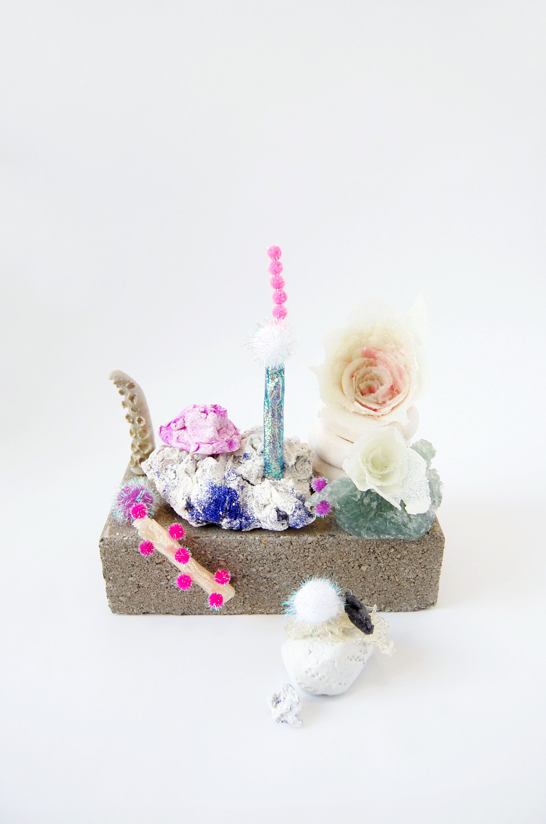    A Garden  , 2016 Brick, glazed ceramic, stoneware, sheetrock joint compound, sheetrock joint compound gel,&nbsp;medium gel, acrylic, glitter glue, pompom, epoxy clay and glitter 9x7.5x7 inches 