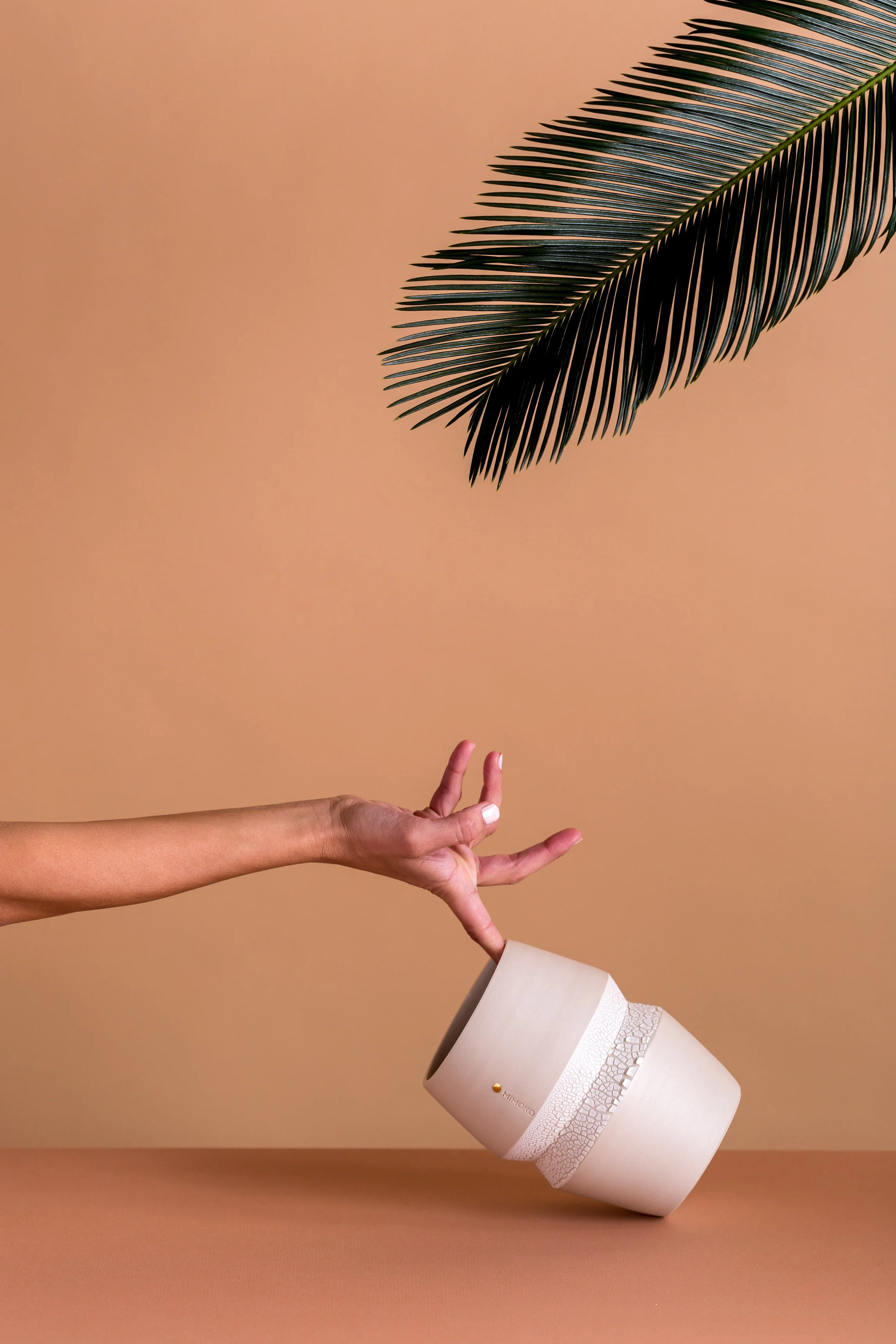 MiMOKO Ceramics | Zag vase leaning over with hand
