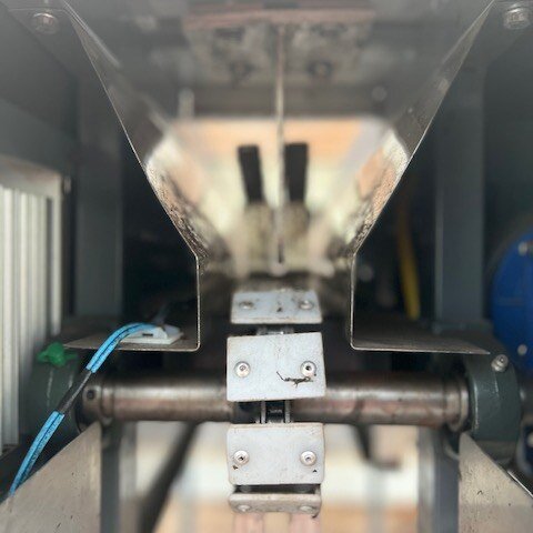 This is our cacao pod splitter that we got from Brazil about 2 years ago! With this machine you are goin to put the pod in through an opening in the top and then place the pod so it is sitting in between the prongs on the conveyor belt. That conveyor