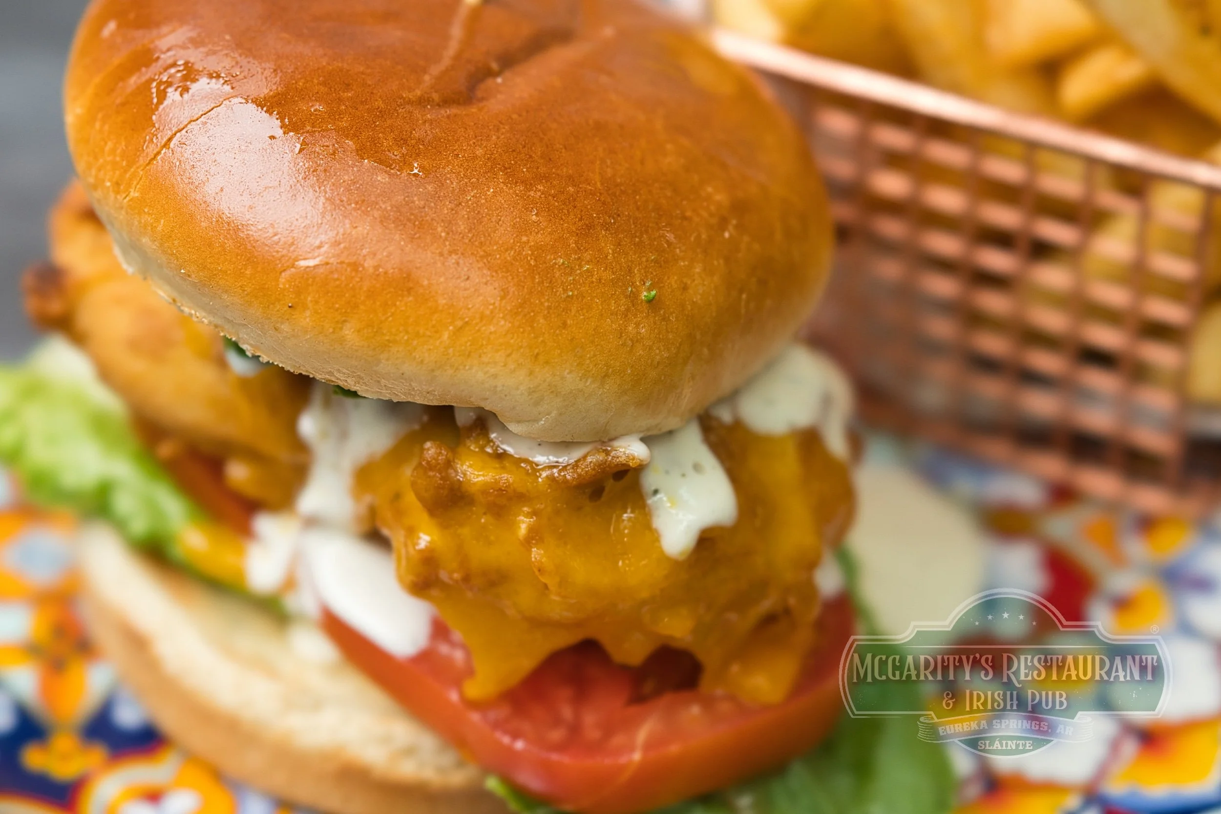 Chicken Sandwich with fried chicken, a brioche bun, and seasoned French fries at McGarity’s in Eureka Springs.