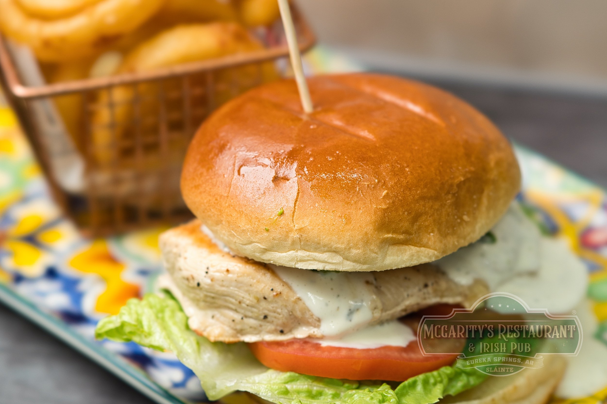 Chicken Sandwich with grilled chicken, a brioche bun, and seasoned French fries at McGarity’s in Eureka Springs.