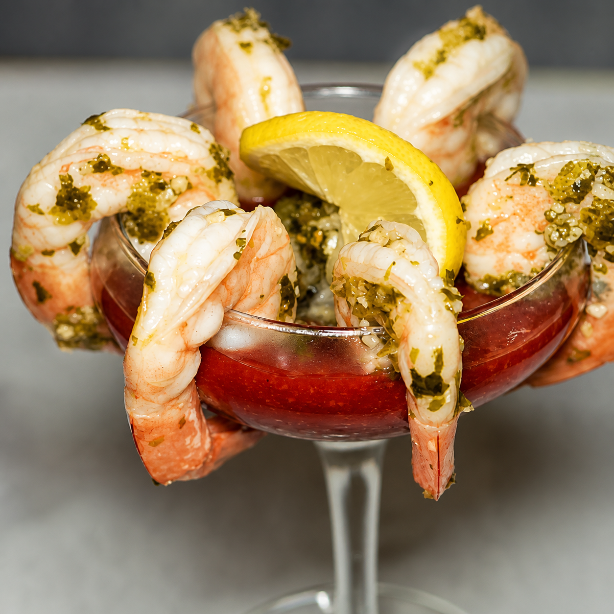 Six jumbo chimichurri-marinated shrimp served in a coupe glass with cocktail sauce and lemon wedges at McGarity’s Restaurant & Irish Pub.