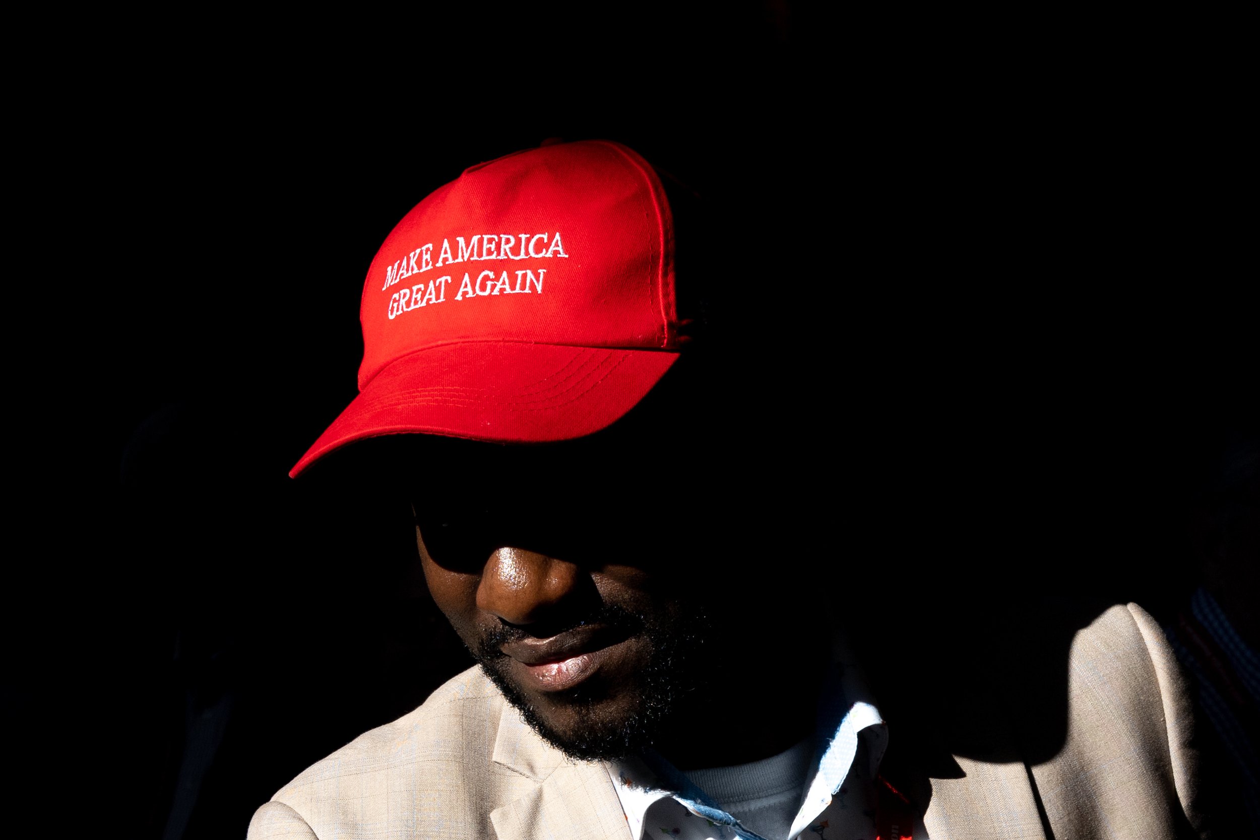  An attendee stands in a patch of light at the Georgia GOP convention in Columbus on Friday, June 9, 2023. 