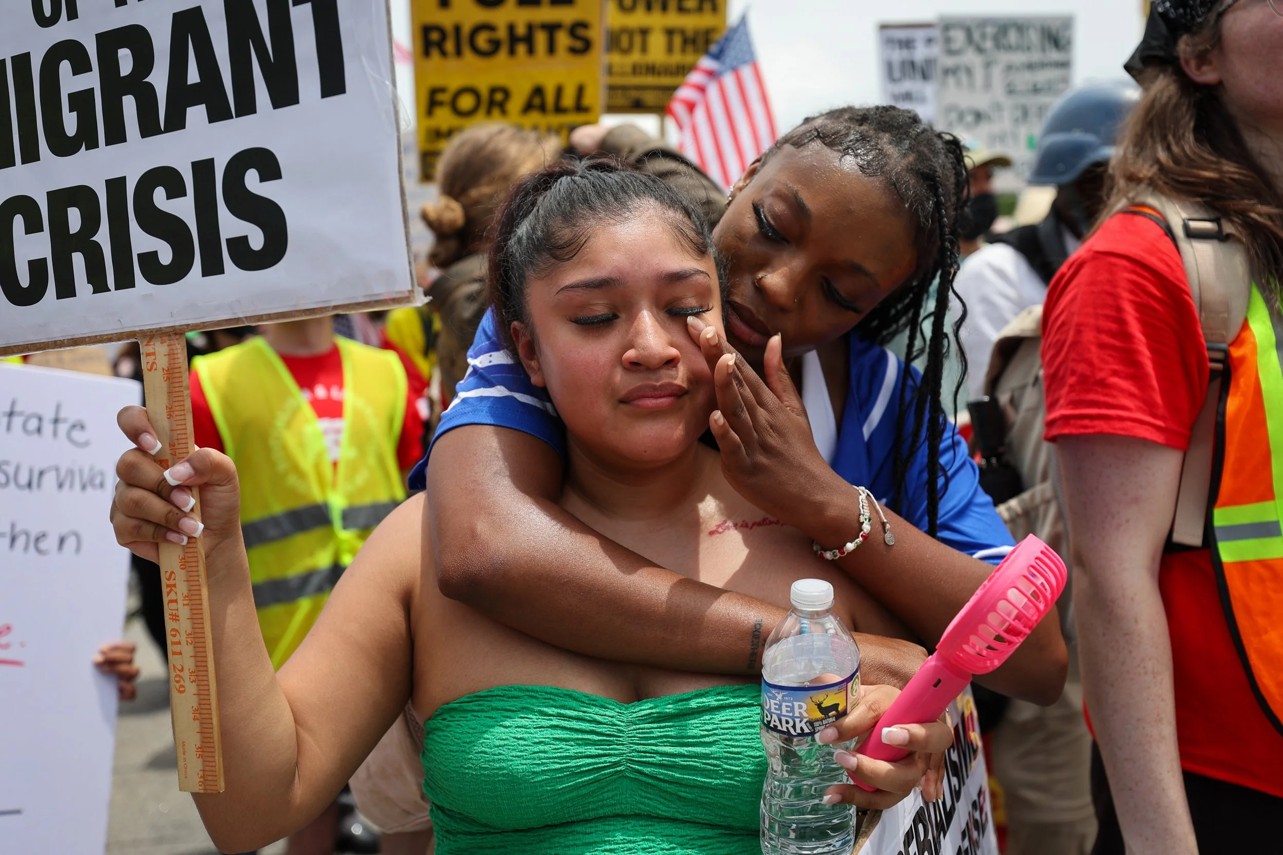  (L-R) Daisy Moran is comforted by Constance Felton as police block their marching route during a protest on ICE raids and deportation arrests on Chamblee Tucker Road in Atlanta on Saturday, June 14, 2025.  