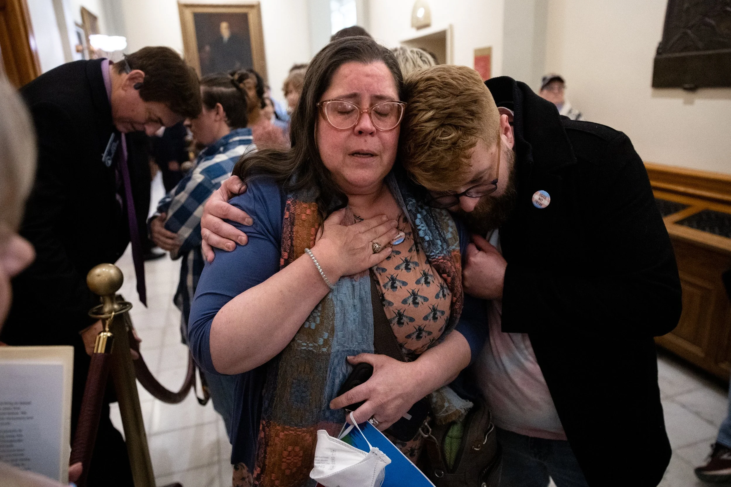  Christine Cox (center), a parent of a transgender teenager, becomes emotional after speaking to state Sen. Carden Summers, R-Cordele, (back left) outside the Senate at the Capitol in Atlanta on Monday, March 20, 2023. Activists appeared at the Capit