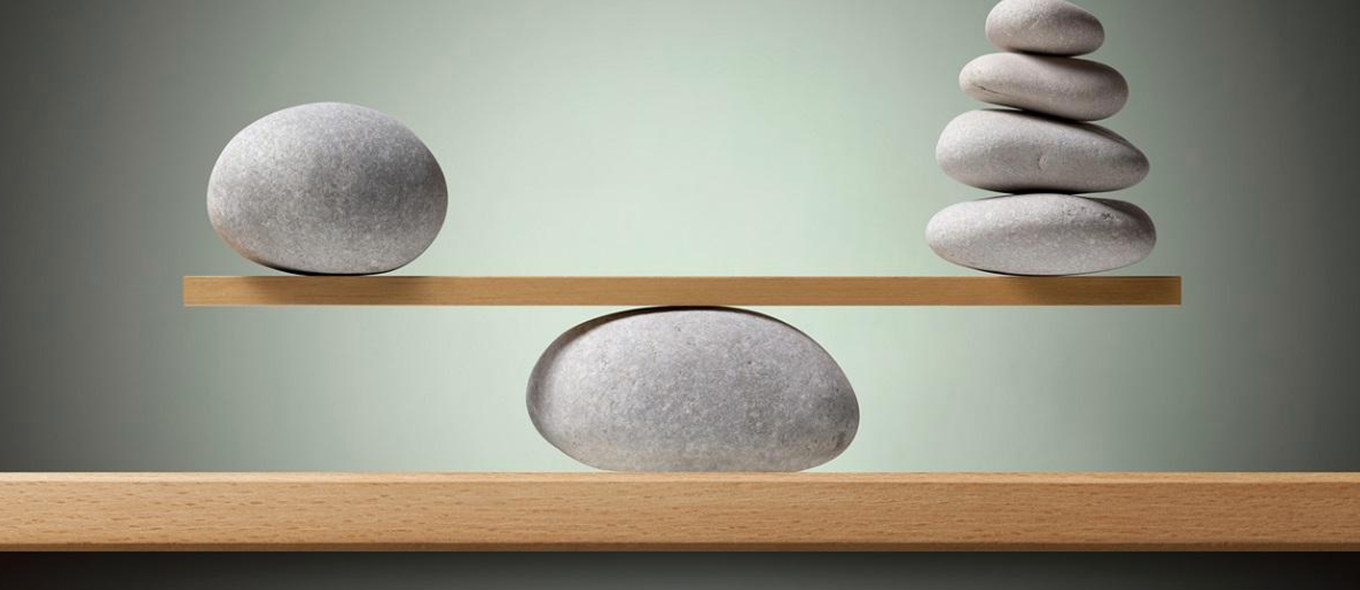 Rocks balanced on a table to represent mindfullness.