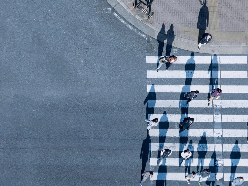 Aerial view of people crossing a city street