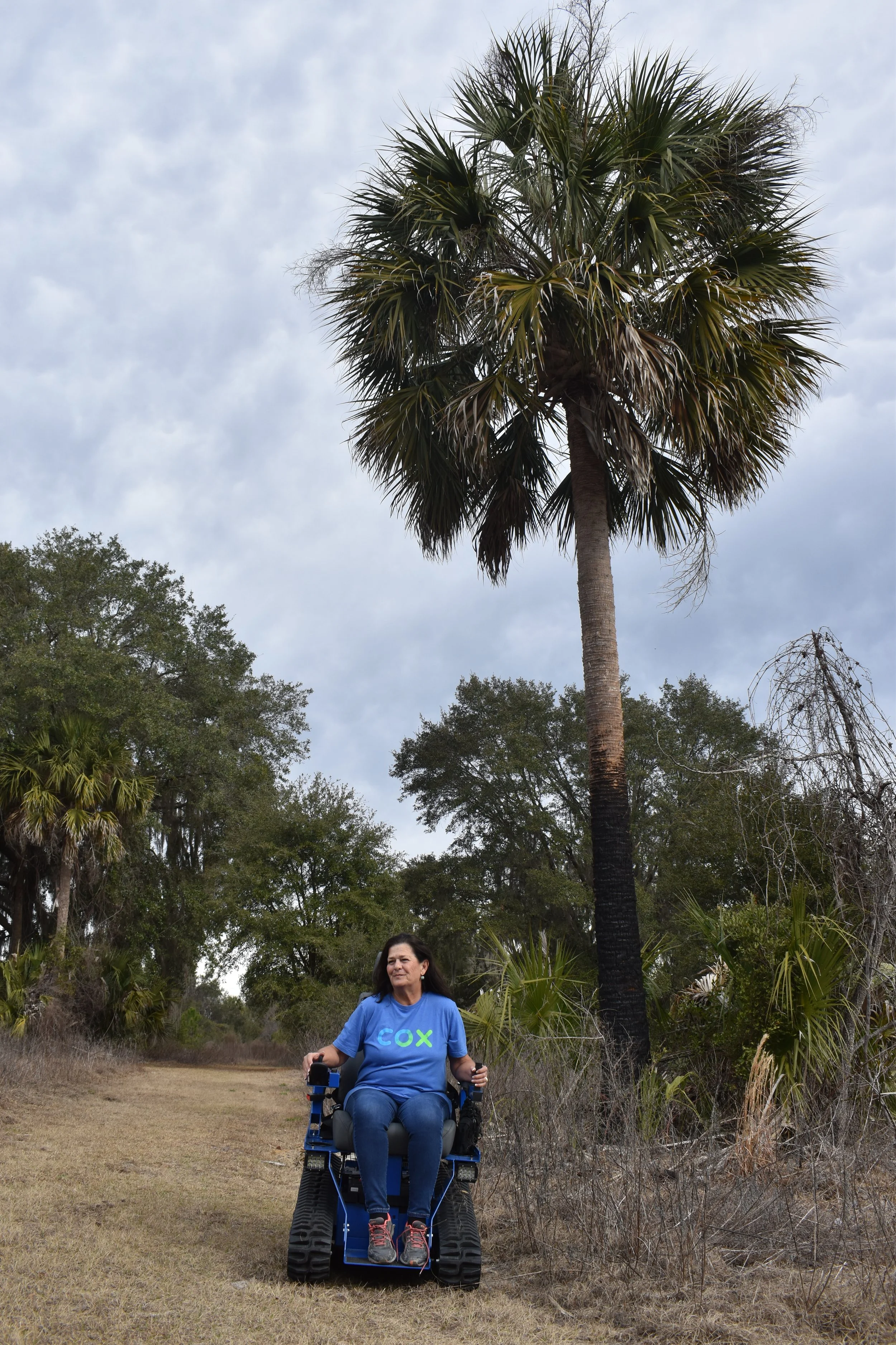 Woman in Cox COmmunications t-shirt in an EcoRover, links to press release