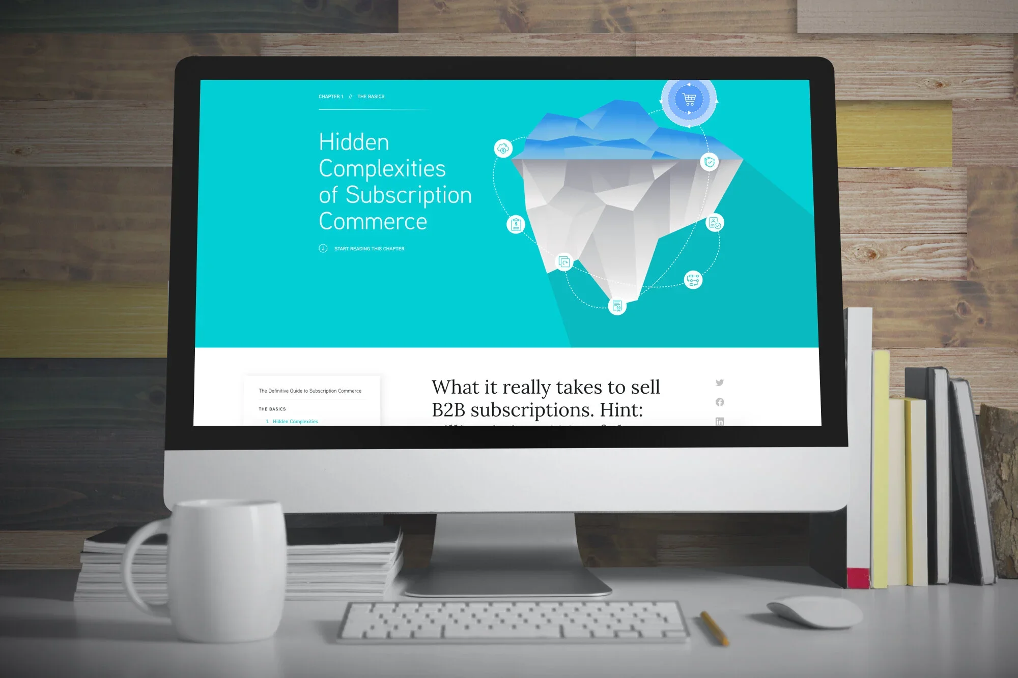 Computer monitor displaying a presentation about the complexities of subscription commerce, with icons and text on a blue background. Desk with a white mug, pen, and stack of papers, in front of a wooden wall.