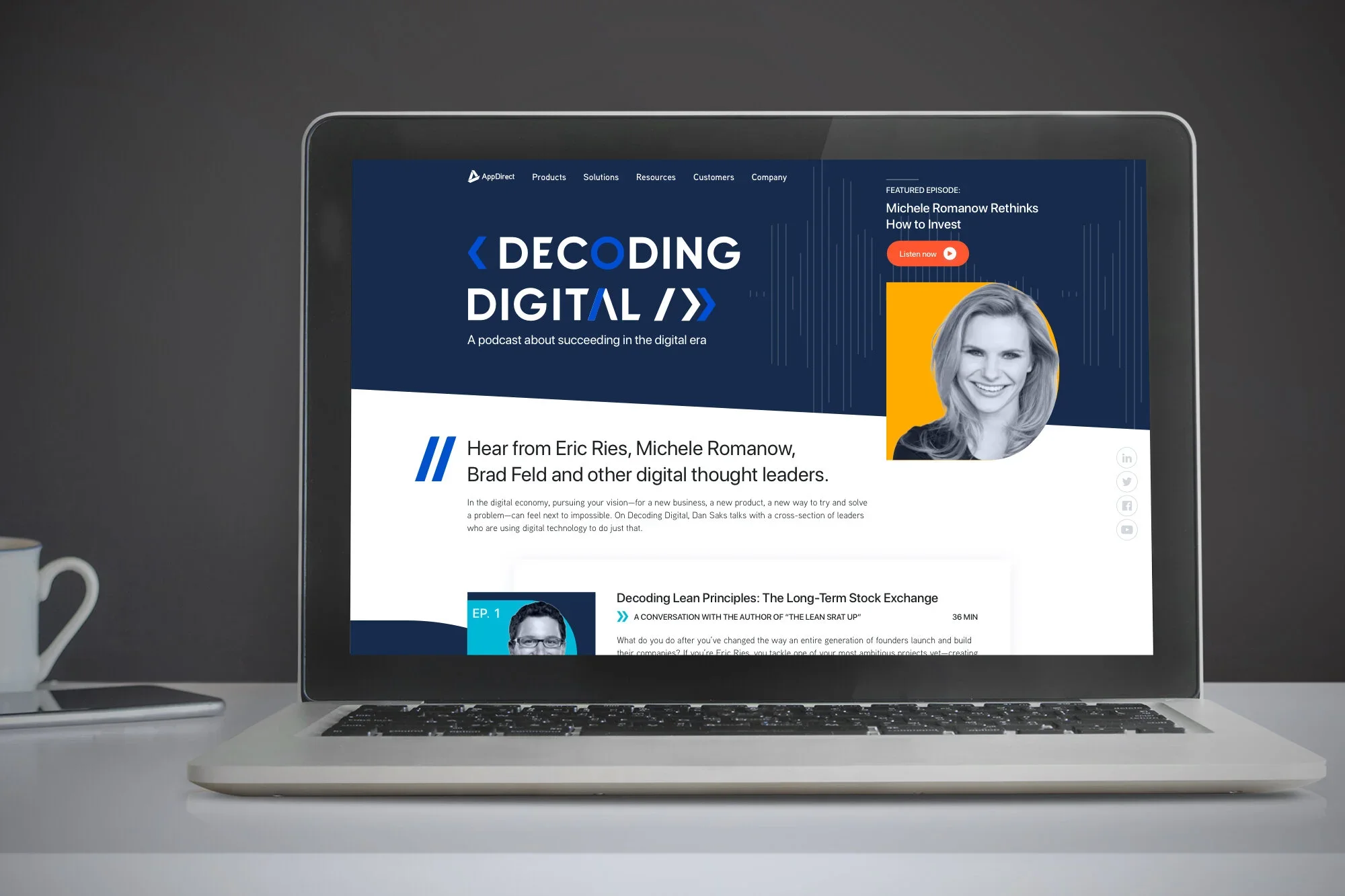 Laptop displaying a podcast webpage titled 'Decoding Digital' with images and text about digital thought leaders and principles, on a gray desk with a white mug to the left.