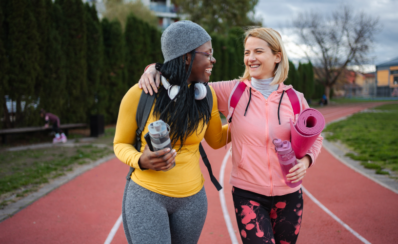 Two women walking on a track