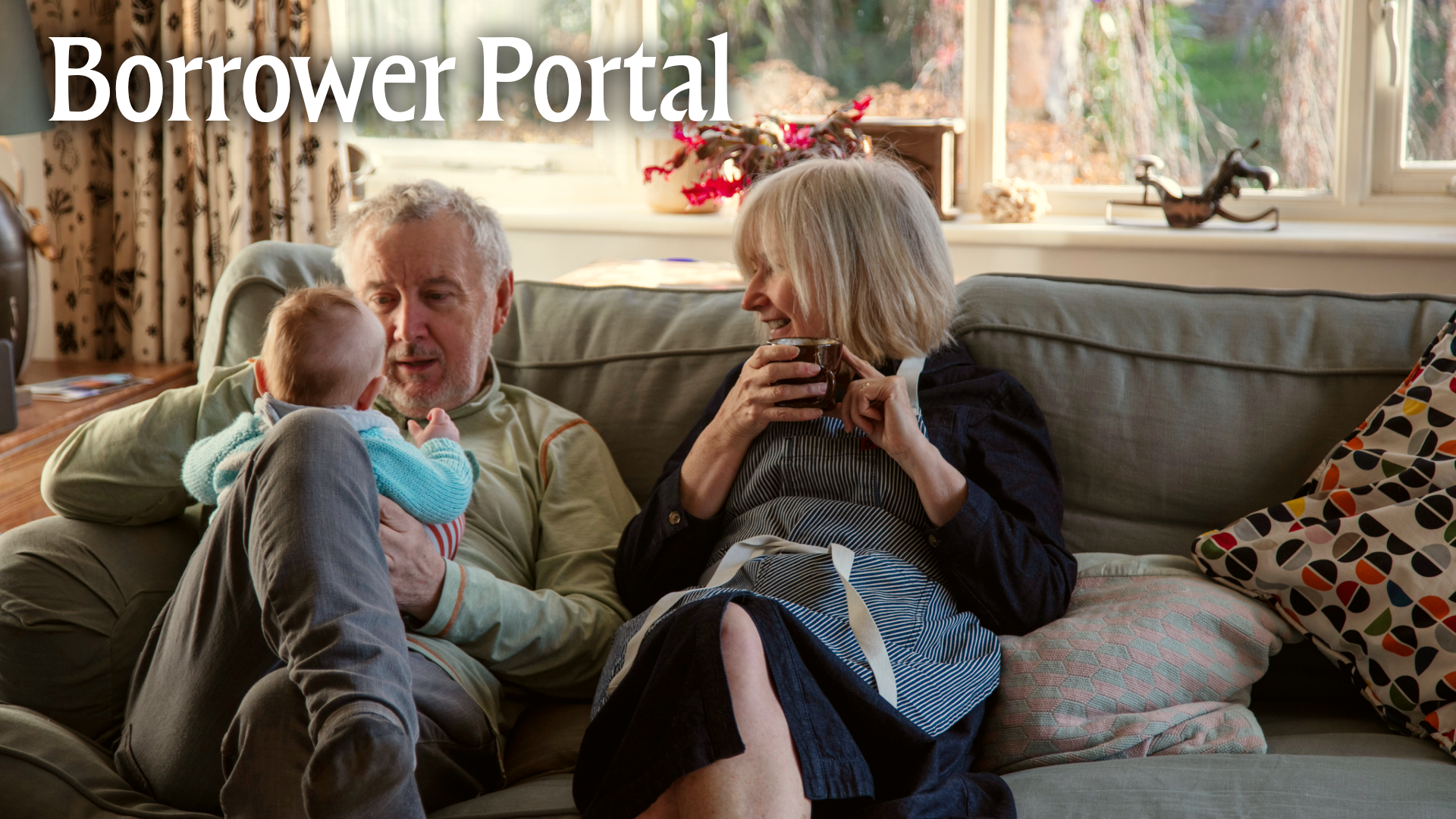 Borrower Portal. Elderly couple with baby on couch.