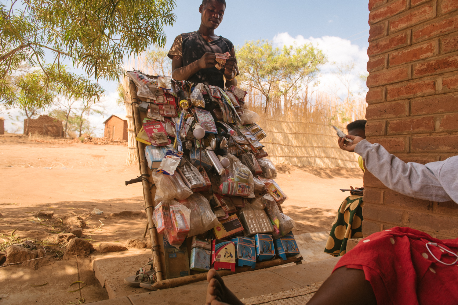 A traveling salesman stops to make a sale as he walks from village to village.