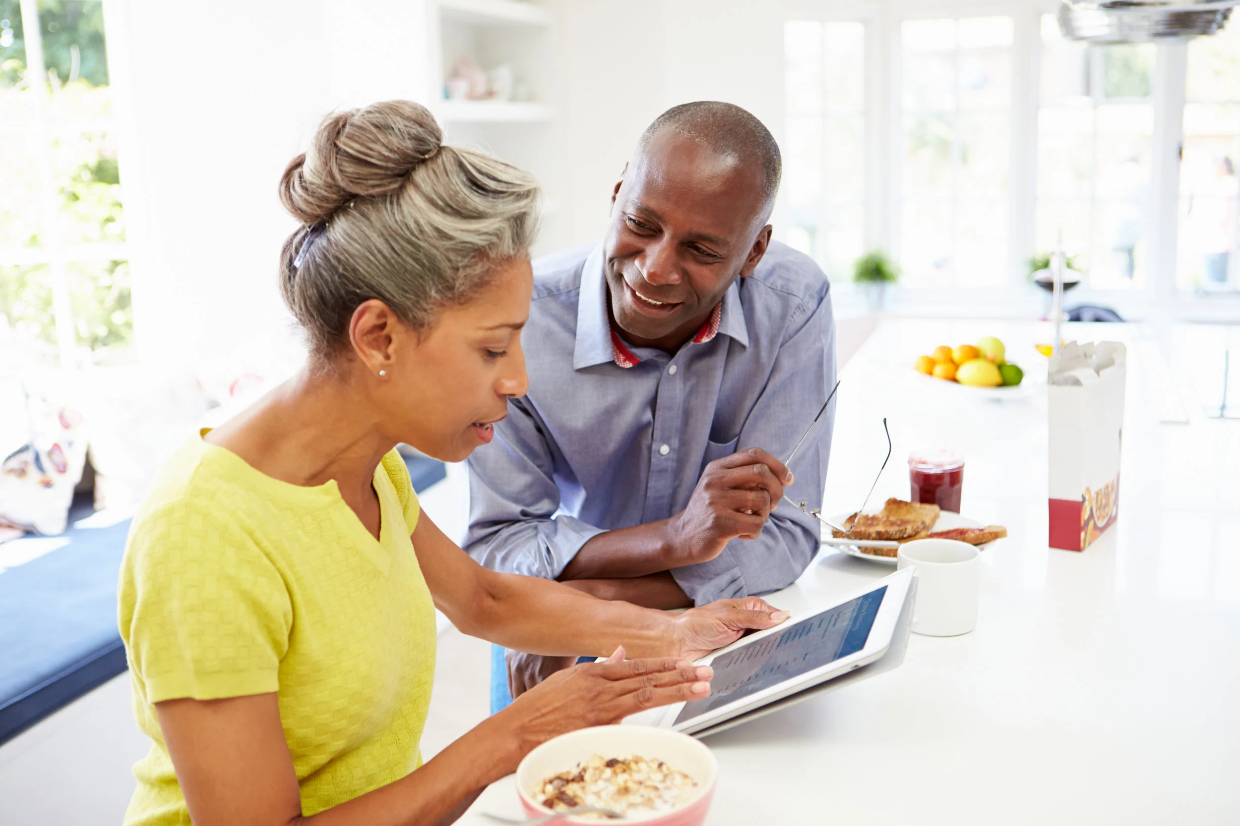 Mature African American Couple Using Digital Tablet At Home.jpeg