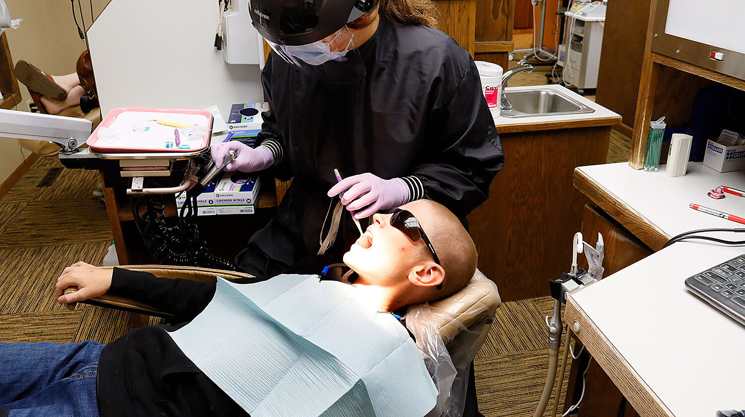 Young-boy-in-dentist-chair-with-sunglasses-on.jpg