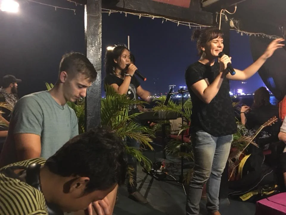 Coraley worshipping on the boat.jpg