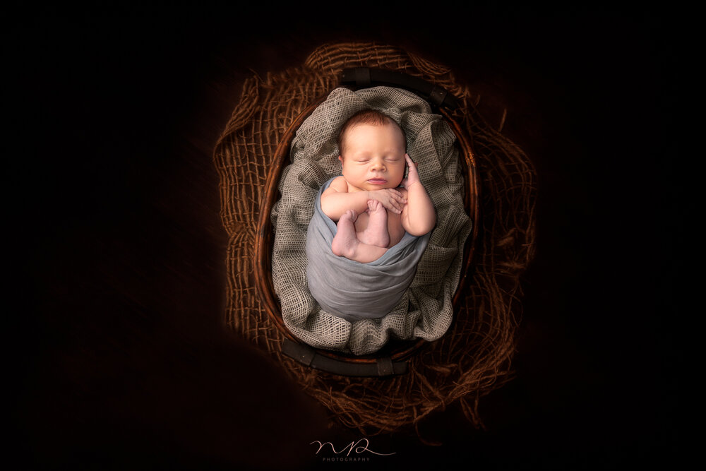 Newborn in a prop by NP Photography