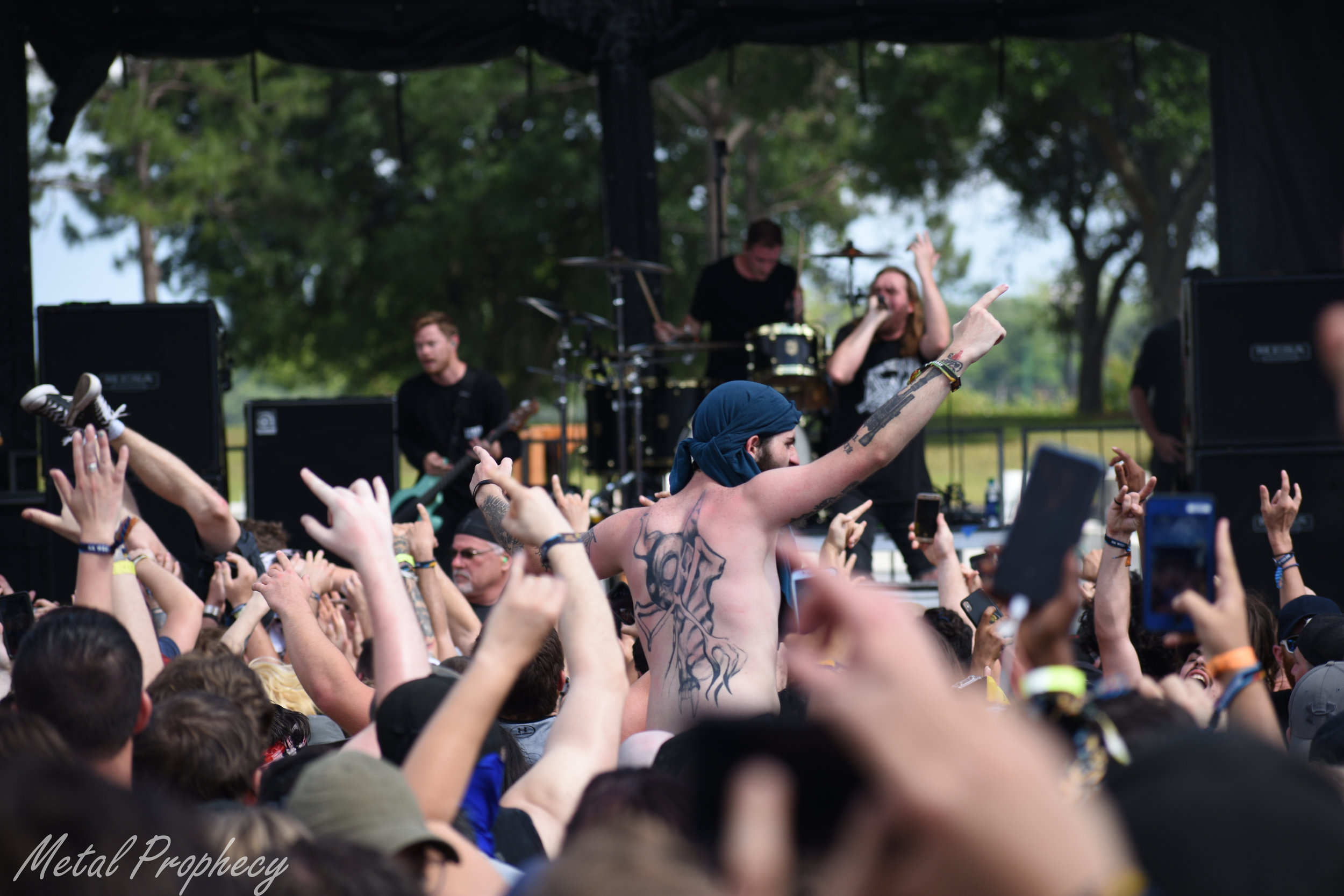 A fan crowd surfs to Wage War at Welcome to Rockville 2019