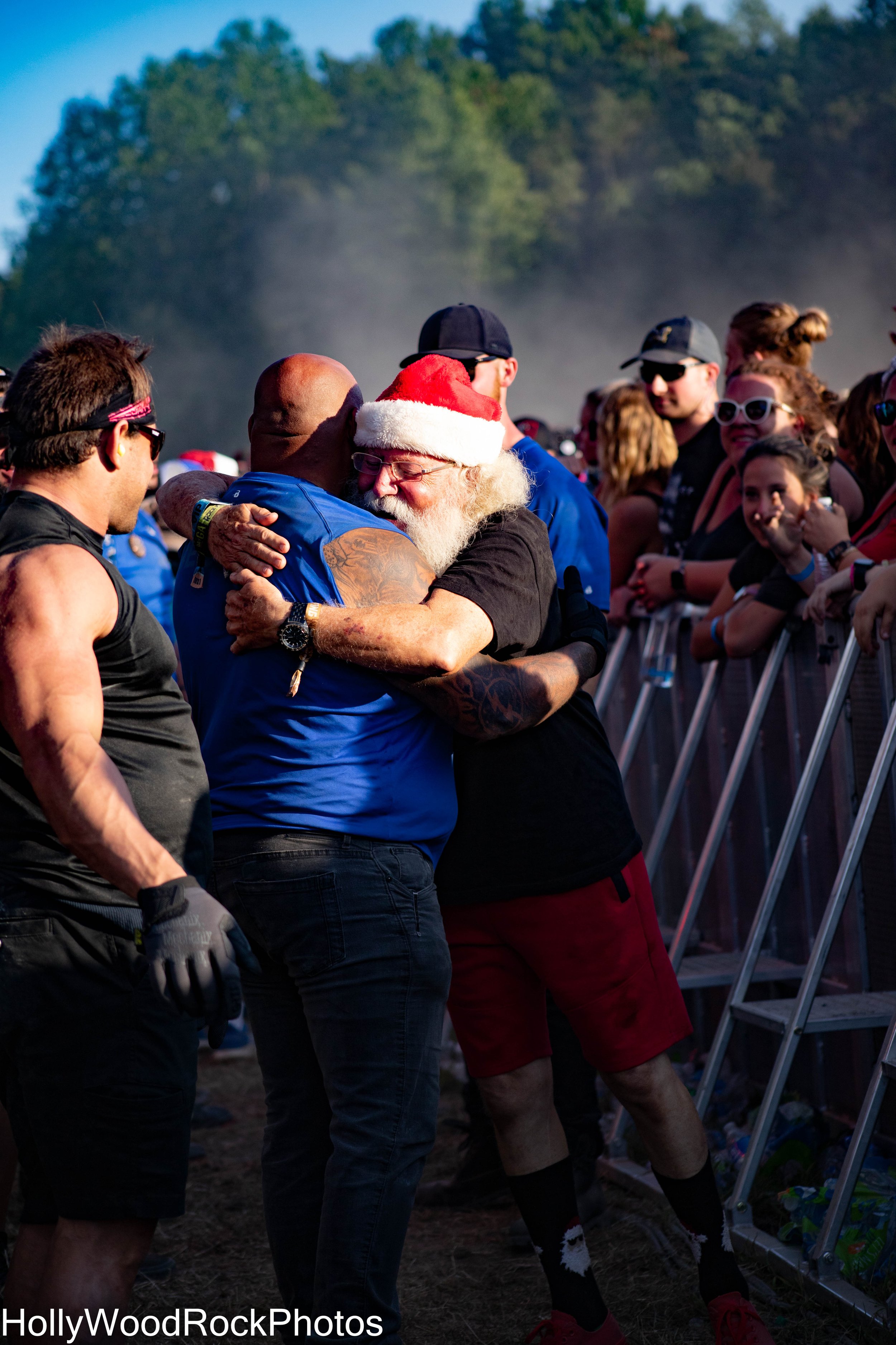 Santa Hugging a Security Guard at Blue Ridge Rock Festival by Holly Williams