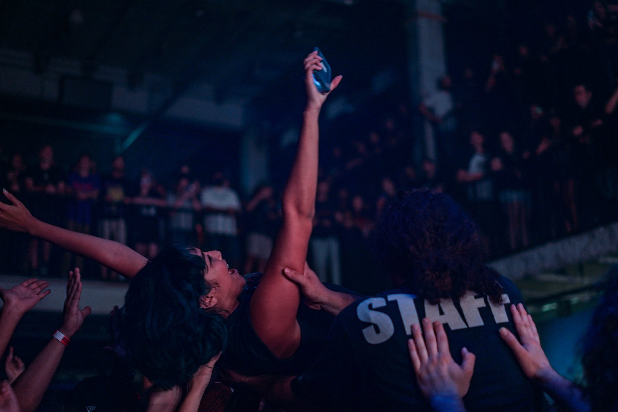 A fan crowd surfs to Erra at The Masquerade