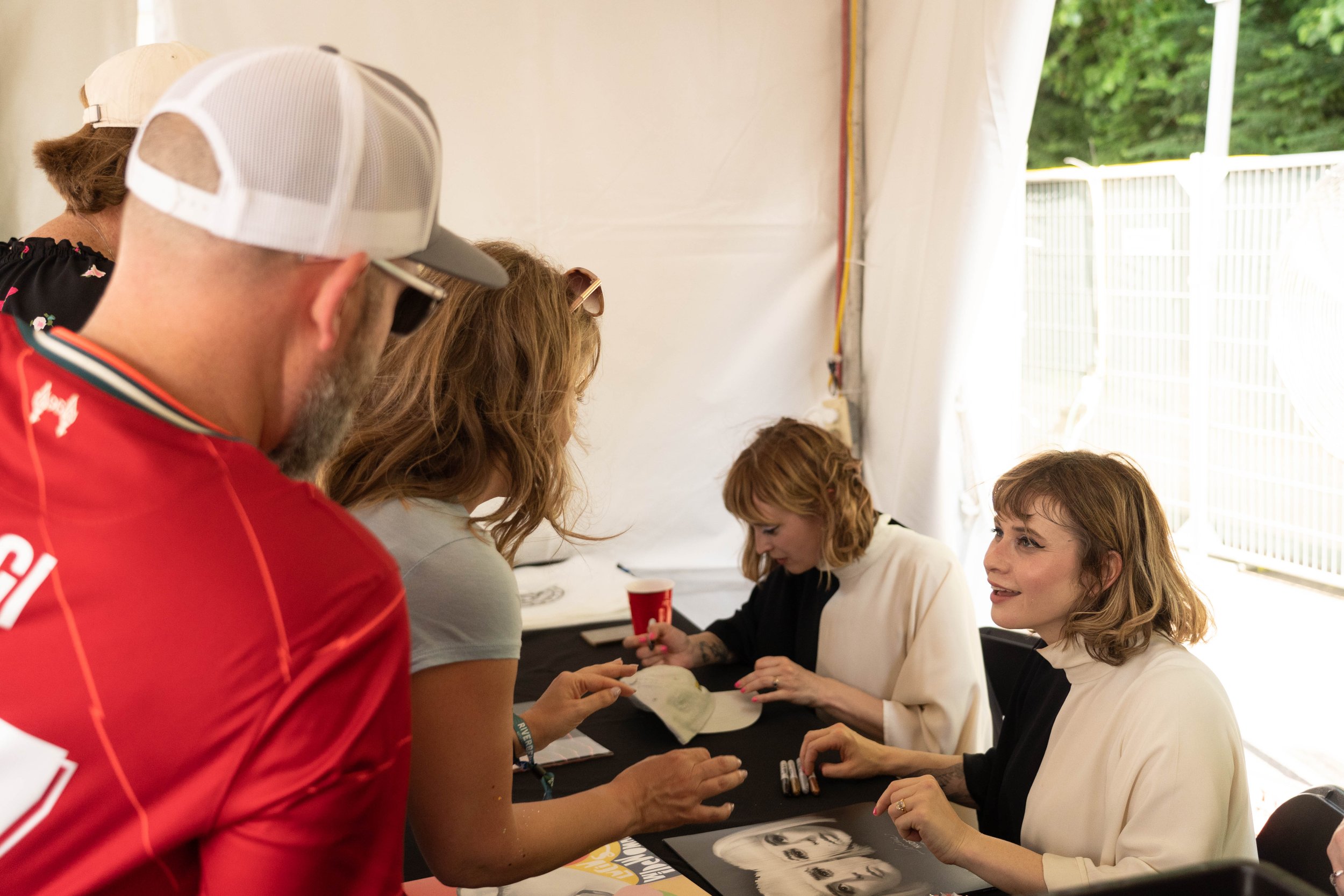 Lucius Signs Records at the Yellow Racket Records Tent at Riverbend Festival 2023