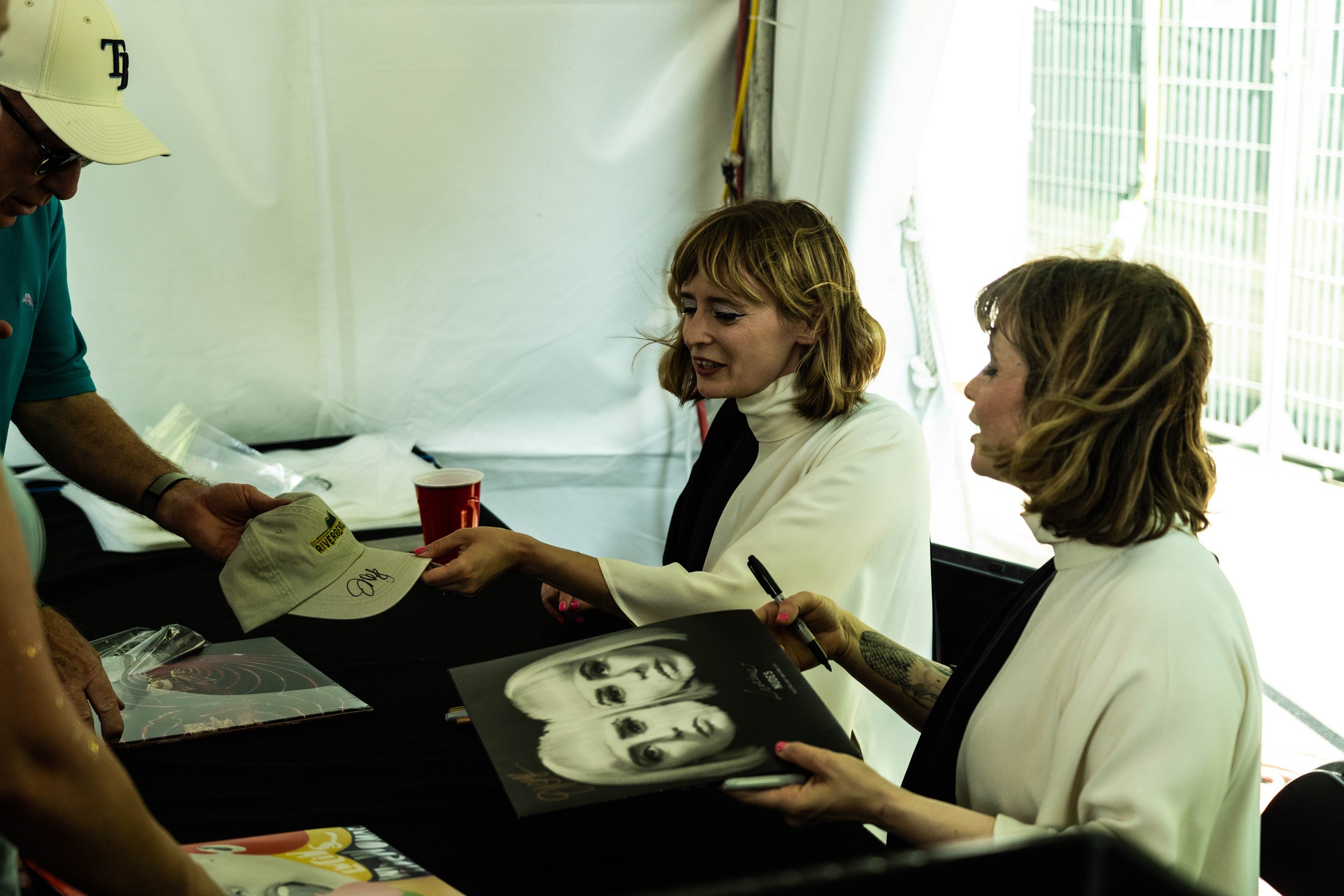 Lucius Signs Records at the Yellow Racket Records Tent at Riverbend Festival 2023