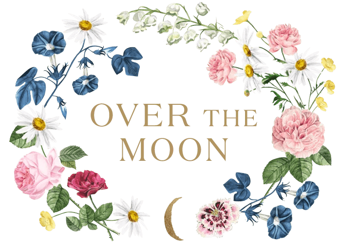 Floral wreath with white, pink, and blue flowers surrounding the text "Over the Moon" and a small crescent moon at the bottom.