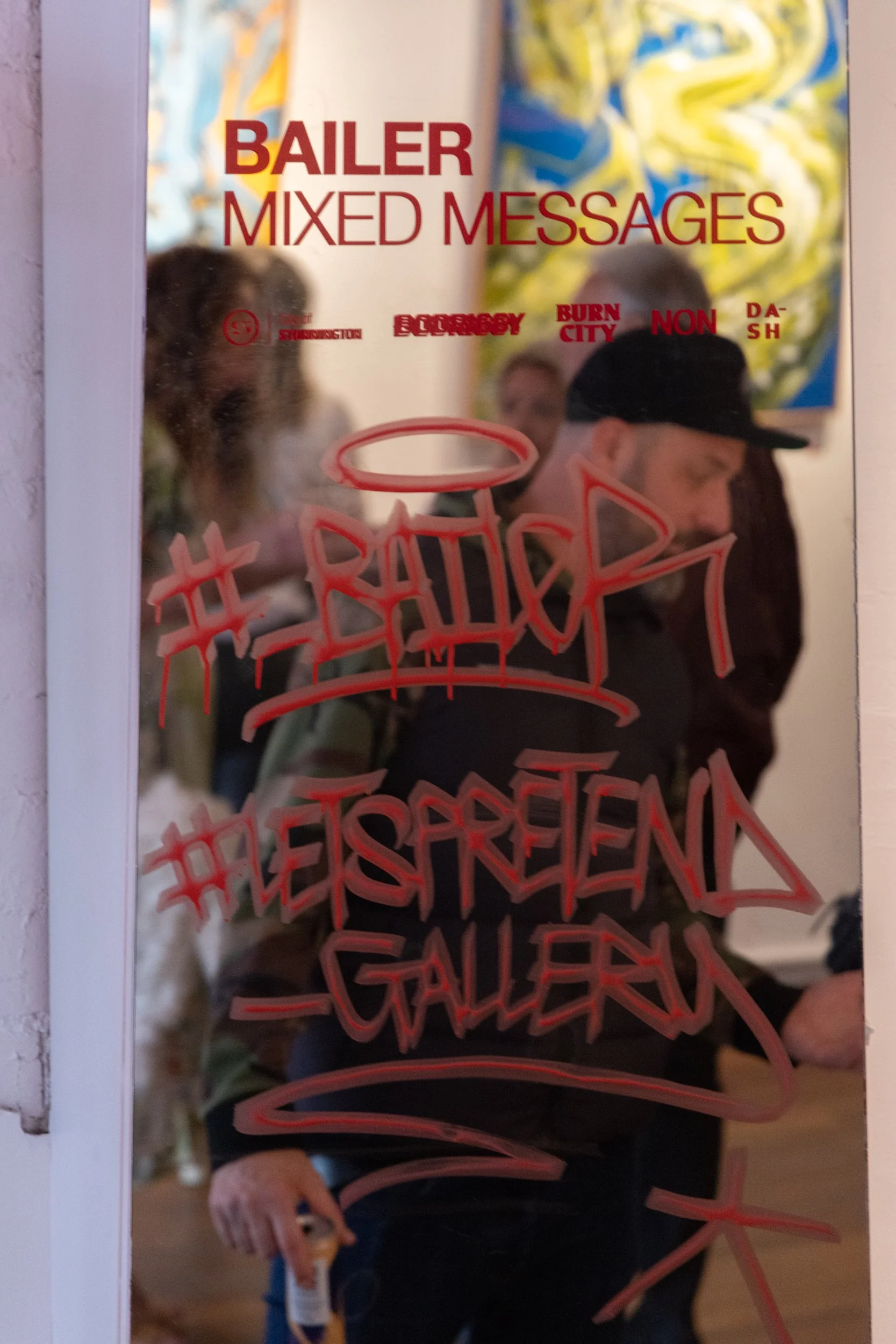Photograph of mirror with tag #Bailer #LetsPretendGallery and vinyl decal at Let's Pretend Gallery. The image is from Melbourne Graffiti Artist Bailer's opening night for their solo exhibition titled 'Mixed Messages'.
