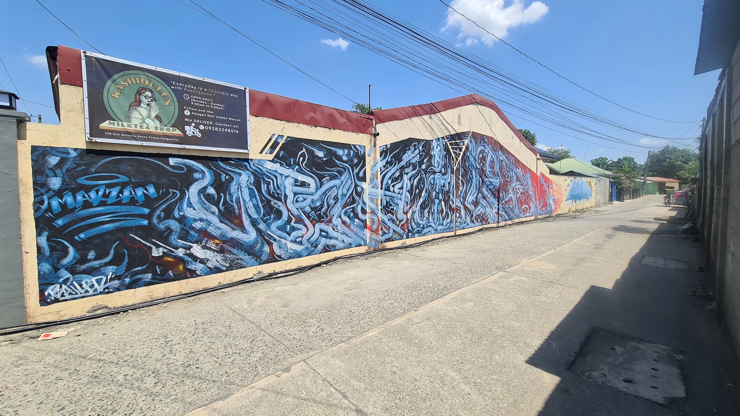 Multiroller, Pangasinan, Philippines: Large-scale Multiroller mural in Pangasinan, Philippines, by Melbourne graffiti artist Bailer, featuring expansive abstract linework across a public facing residential wall.