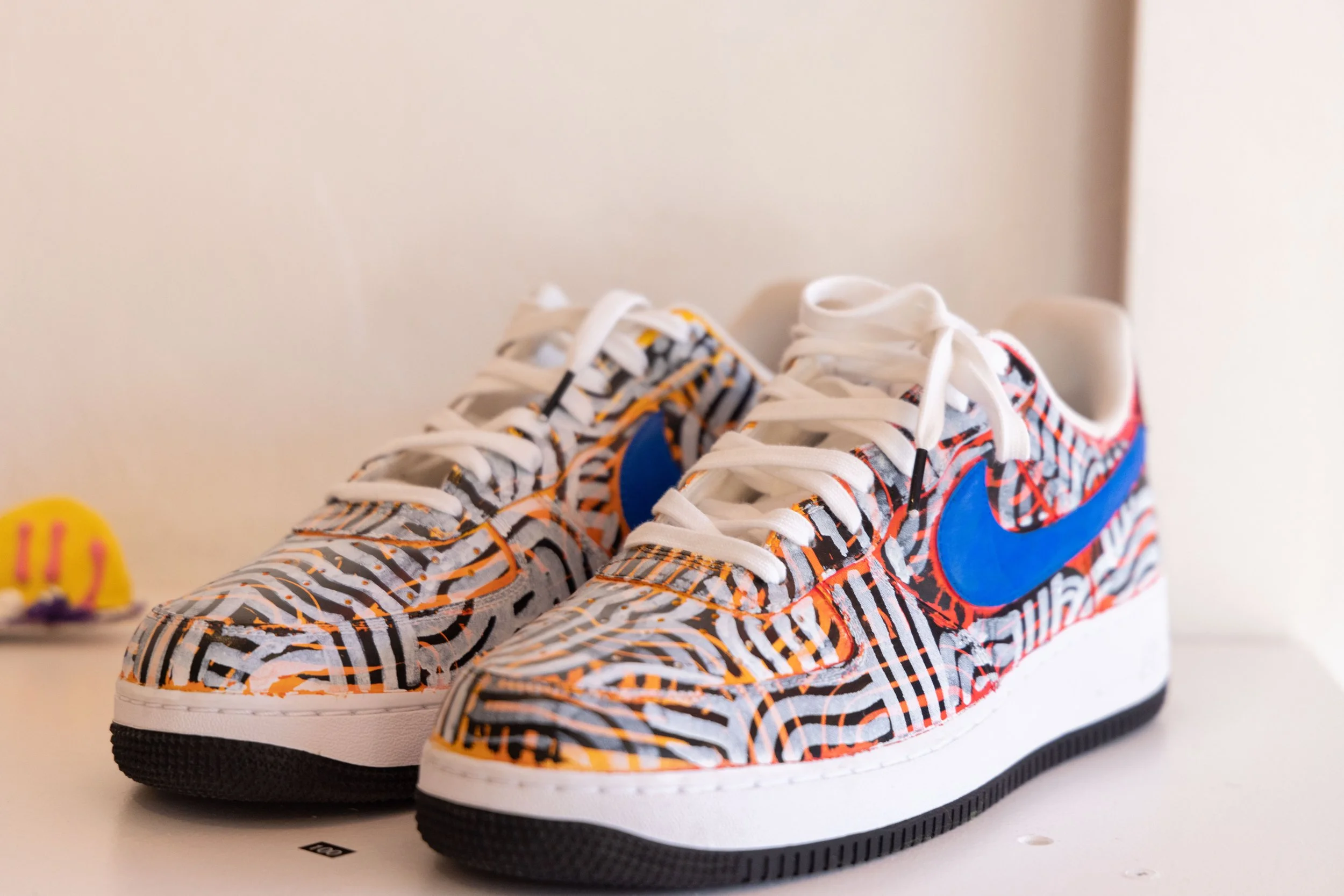 Photograph of Nike Air Force One Men's Shoes painted by Bailer at Let's Pretend Gallery. The image is from Melbourne Graffiti Artist Bailer's opening night for their solo exhibition titled 'Mixed Messages'.