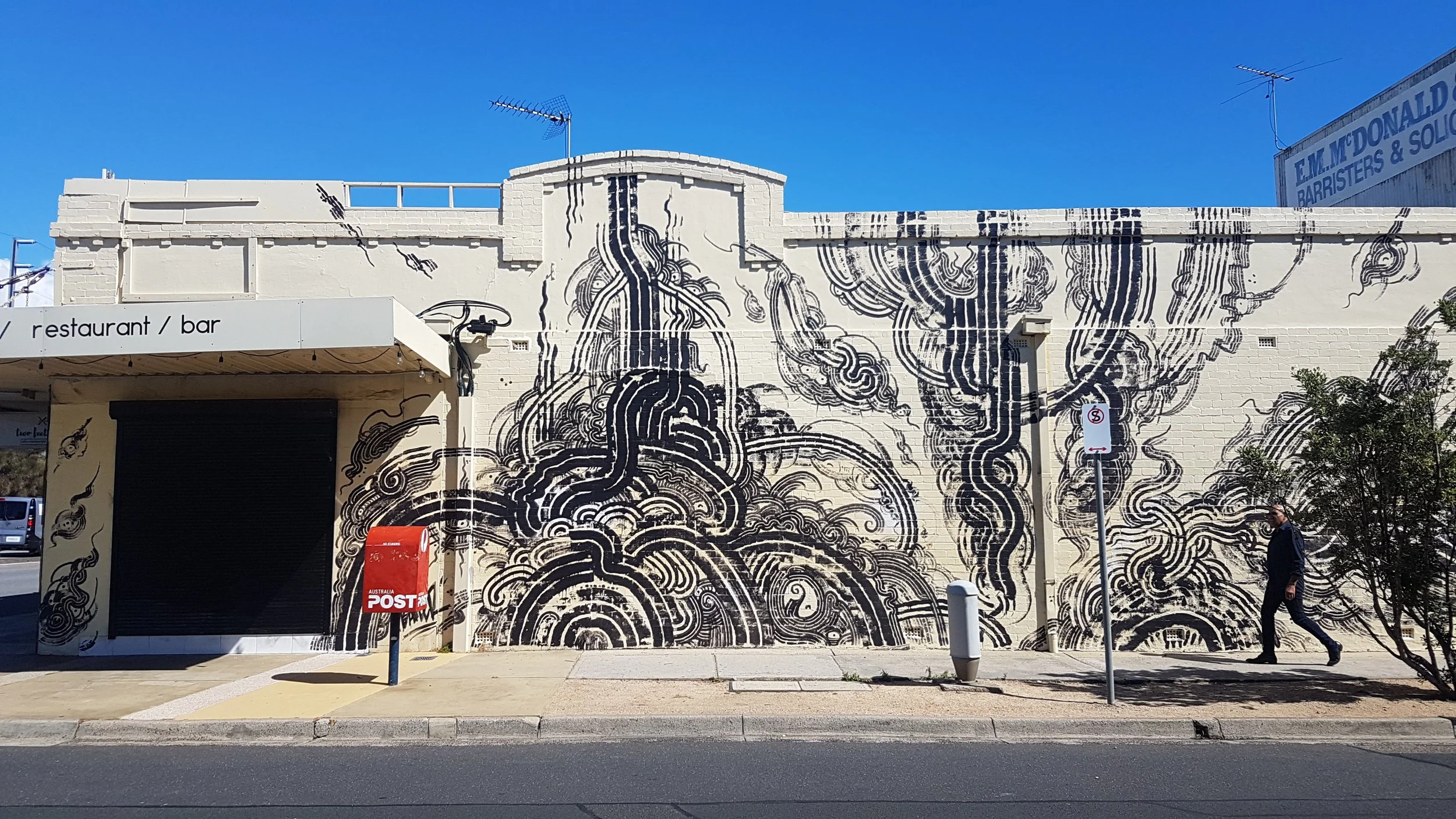 Multiroller, Cheltenham: Cheltenham cafe mural by Melbourne graffiti artist Bailer, featuring black-and-white abstract Multiroller forms inspired by symbols and ancient lettering.