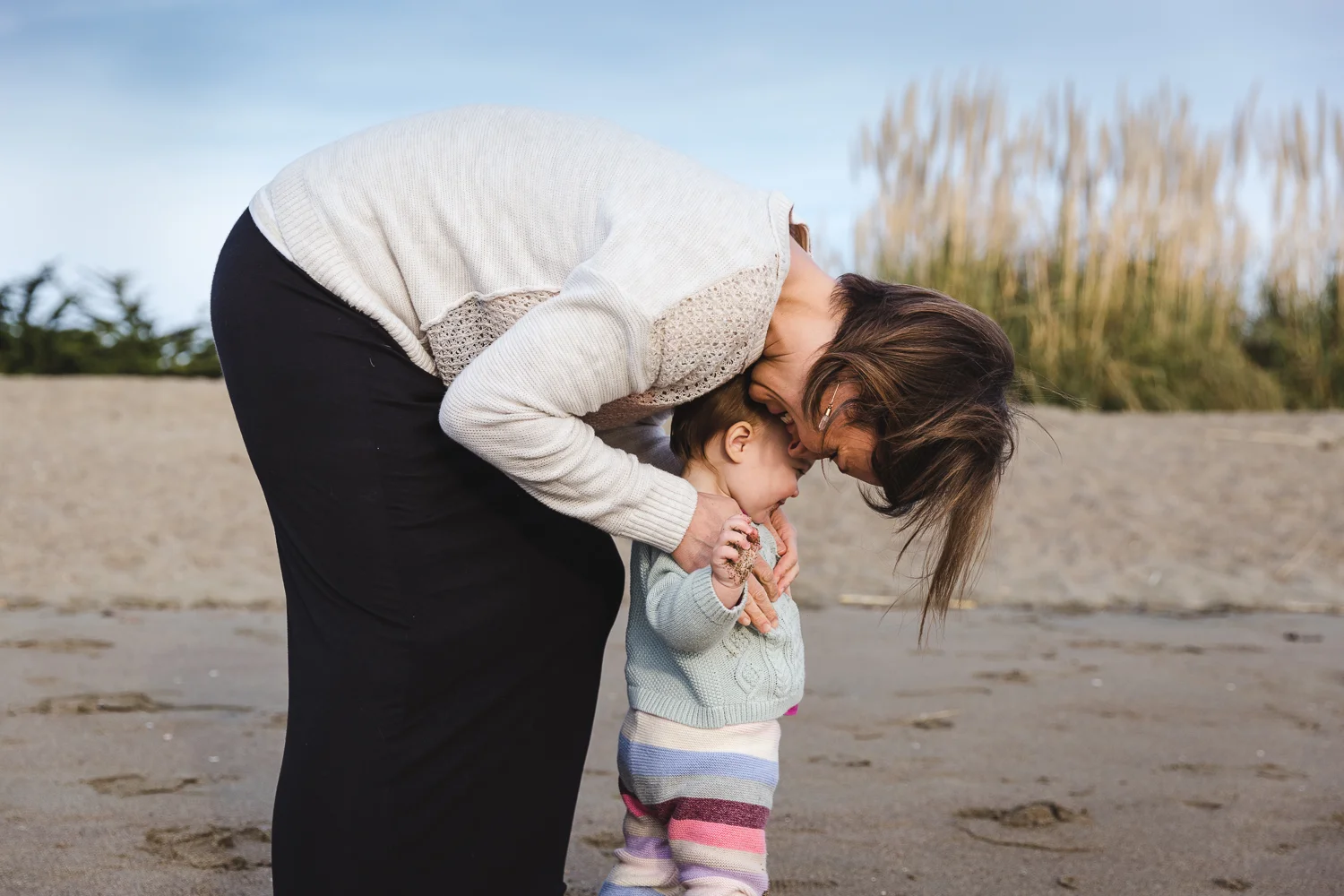 mother and baby on the beach snuggling each other {east bay family photographer}