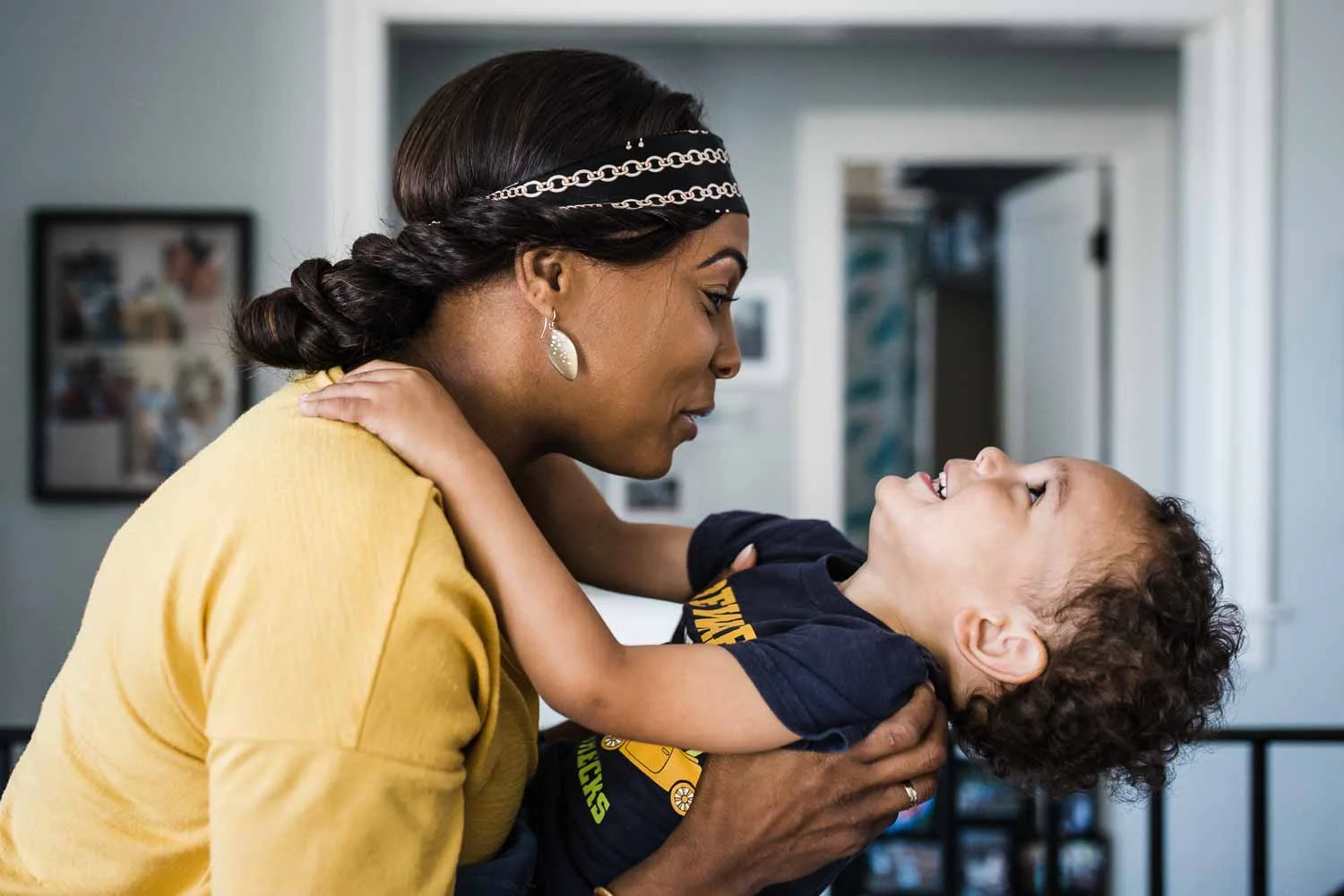 Mom holding son back as they both smile {San Francisco Family Photographer}