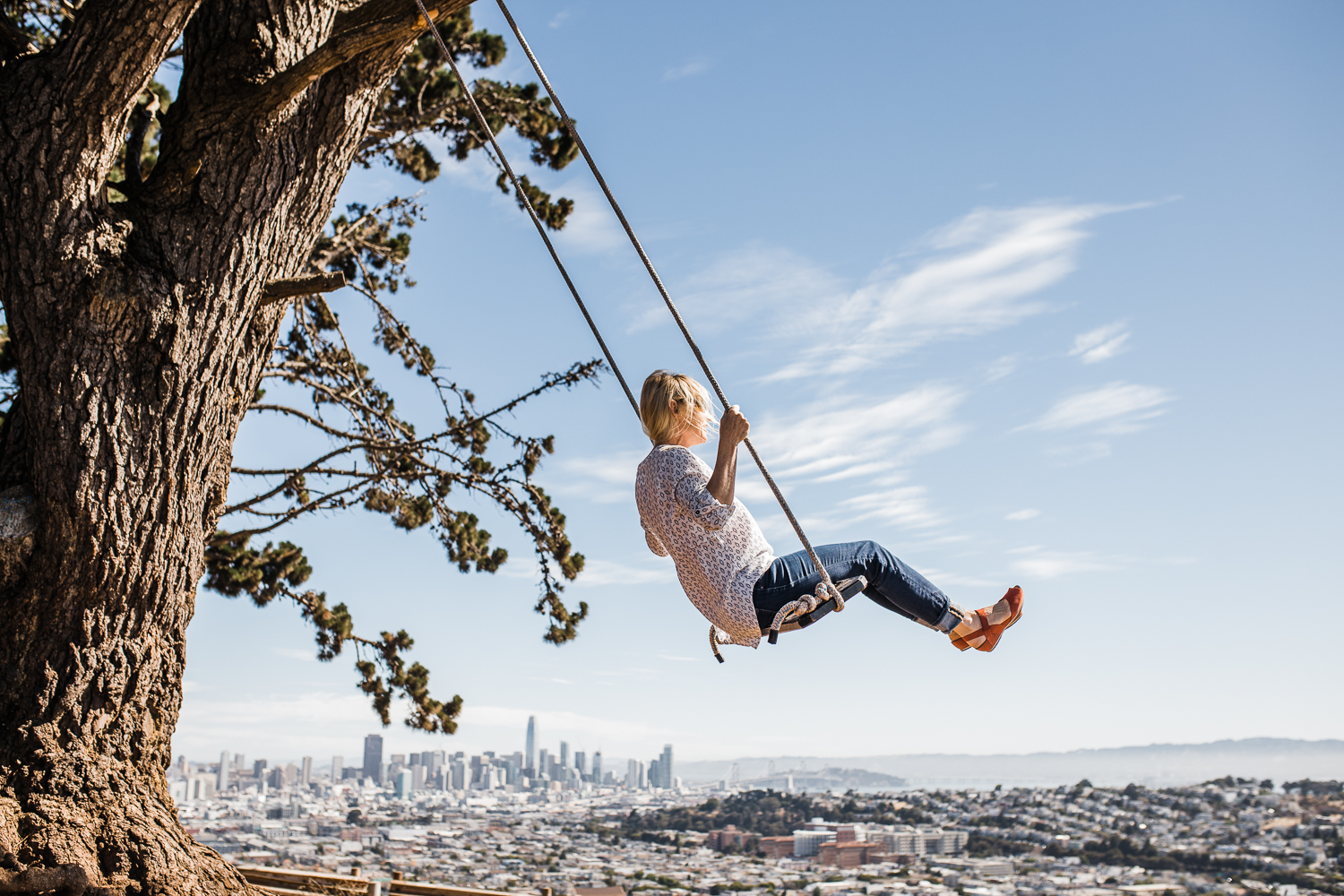 Mom swinging with a view overlooking the city {San Francisco Lifestyle Family Photographer}