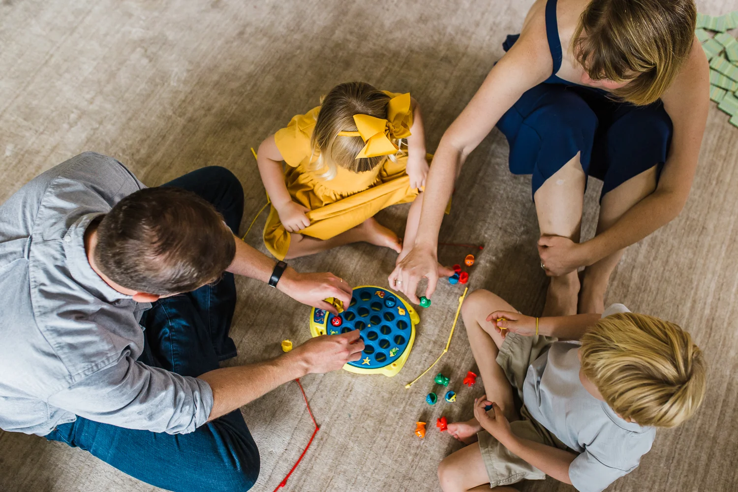 birdseye view of a family of four playing a board game together {East Bay in-home lifestyle Family Photographer}