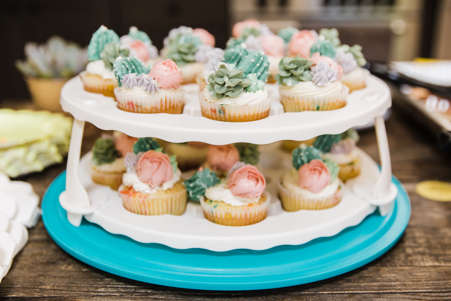 a two-tier tray of cupcakes at a gender reveal party {San Francisco Family Photographer}