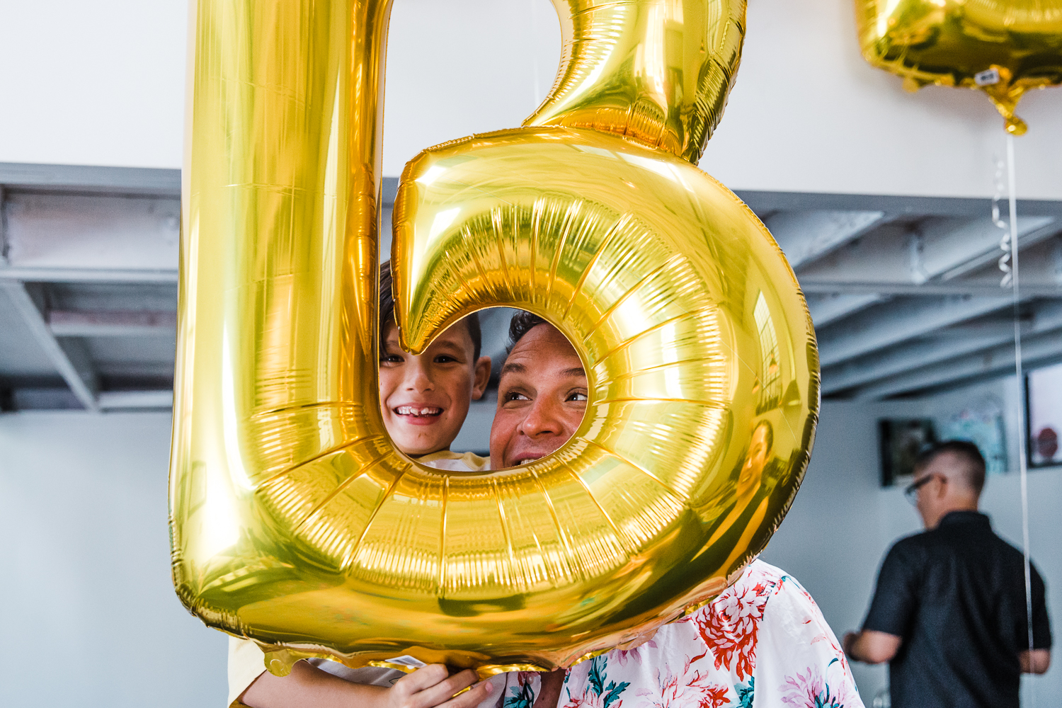 Dad and a boy looking through a balloon at a gender reveal party {SF Family Photographer}