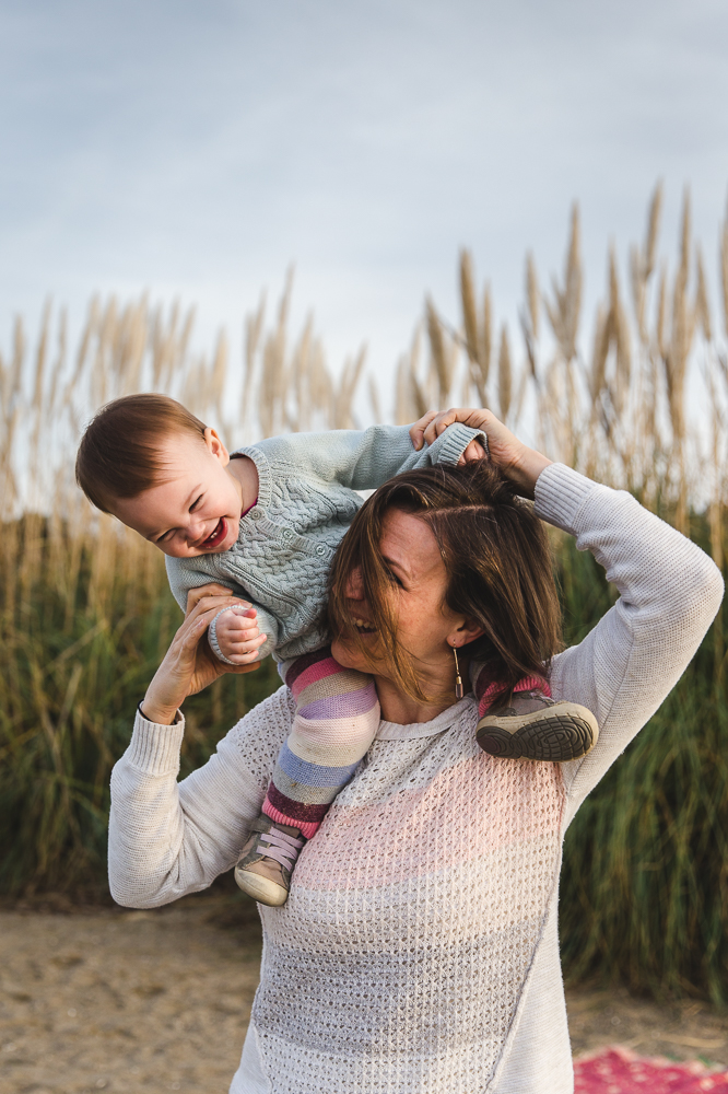 Mom holding her one year old baby on her shoulders as they both laugh {East Bay Baby Photographer}