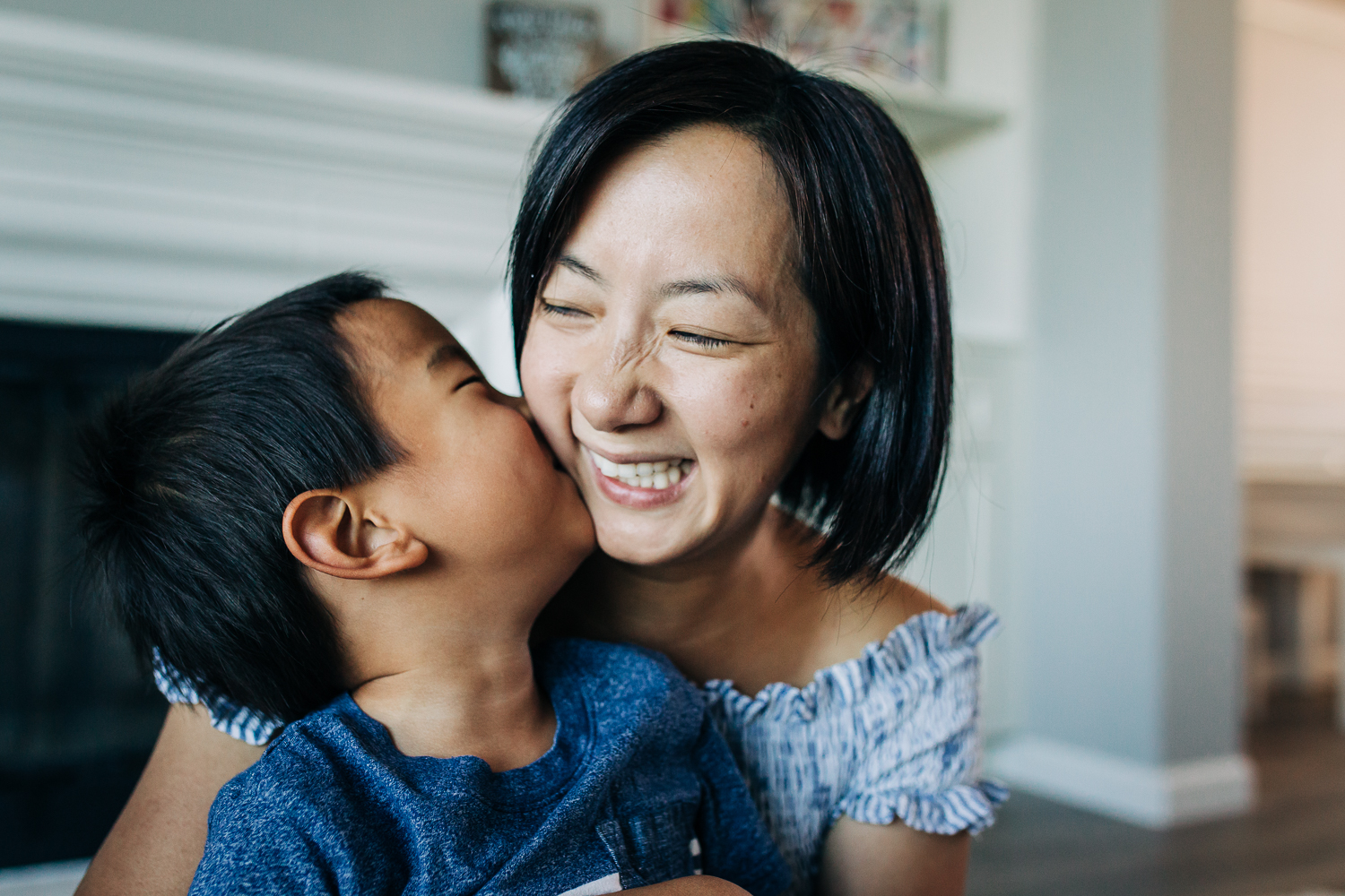 little boy kissing his mom as she smiles | East Bay Lifestyle Family Photographer
