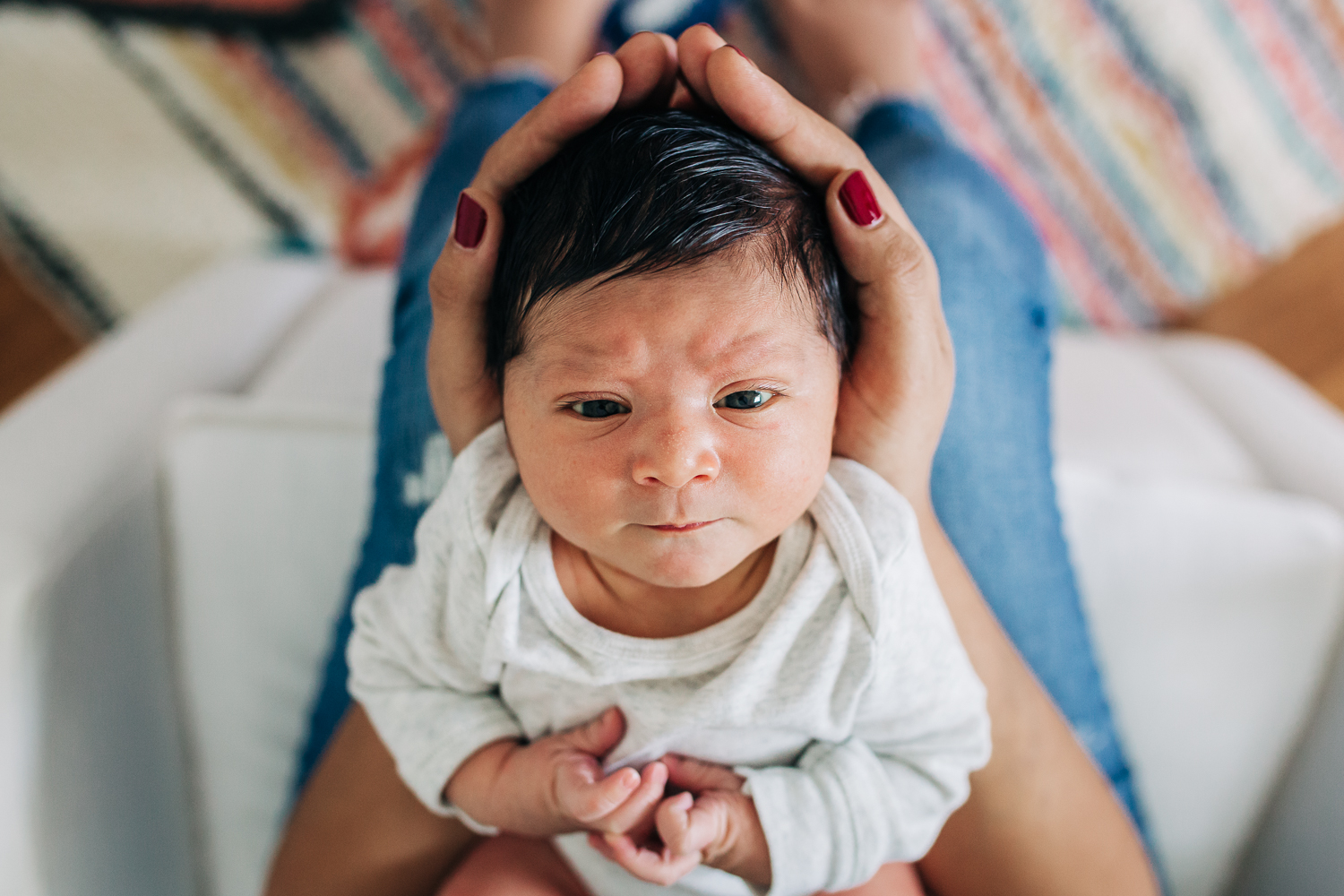 birdseye view of a newborn baby boy held in his mother's arms | SF Baby Photographer