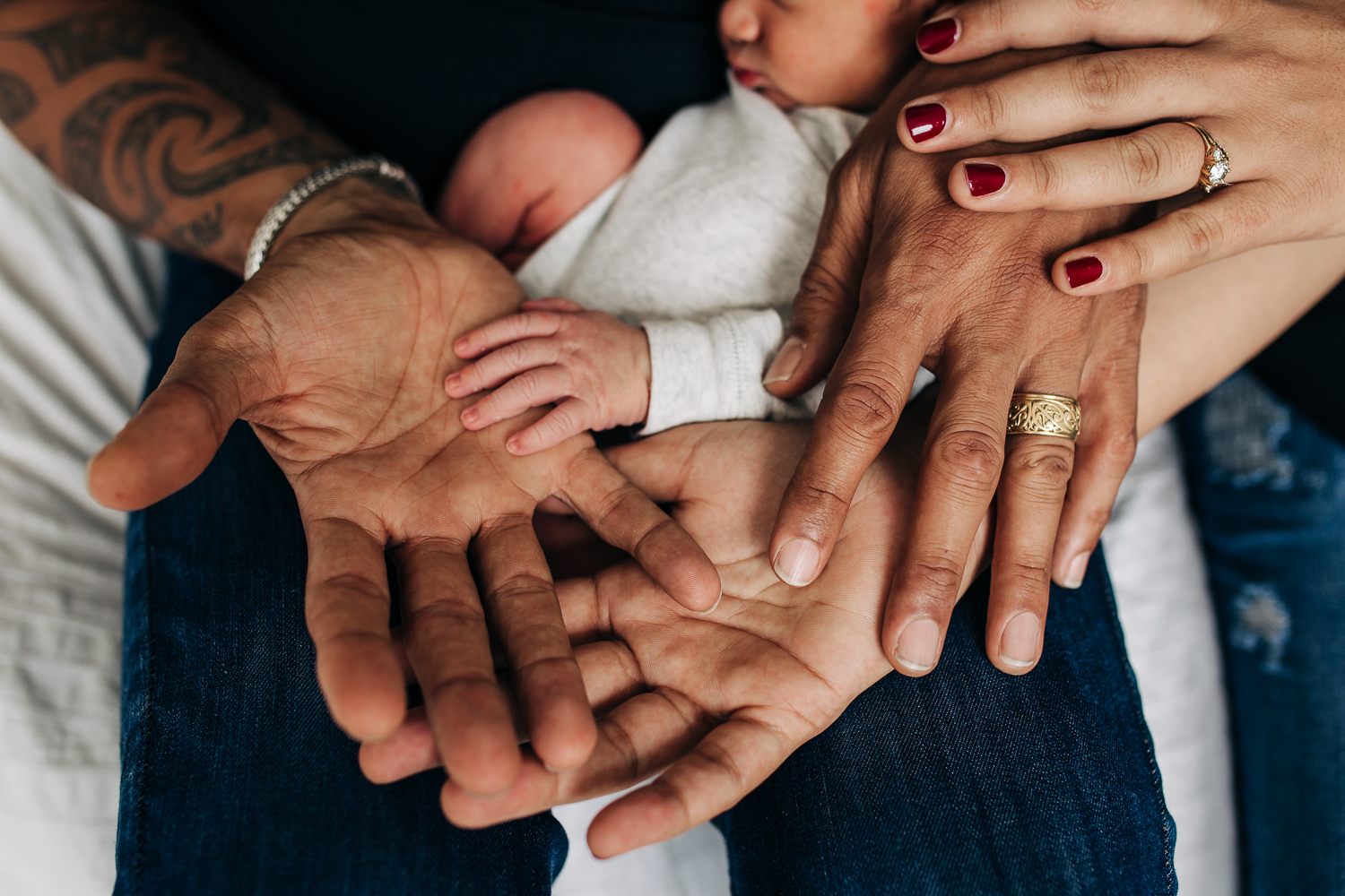 Mother, father, and newborn baby boy displaying their hands together | San Francisco Newborn Photographer