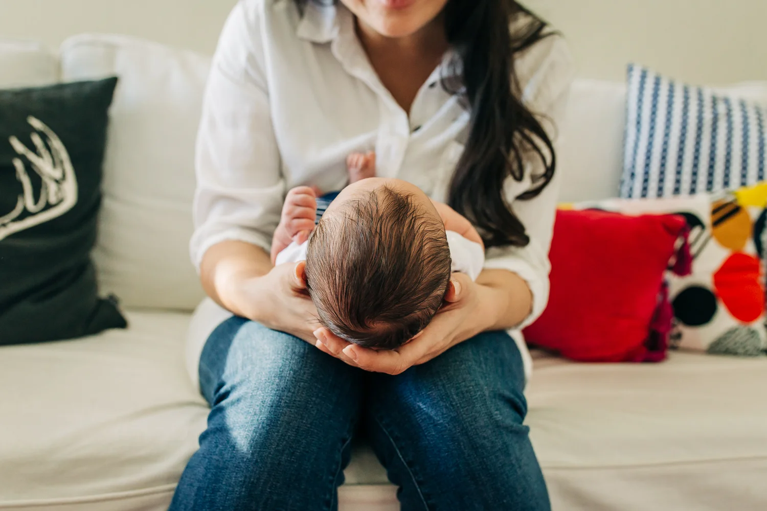 Close up of baby boy's head as mom holds him and looks down at his face | SF Newborn Photography
