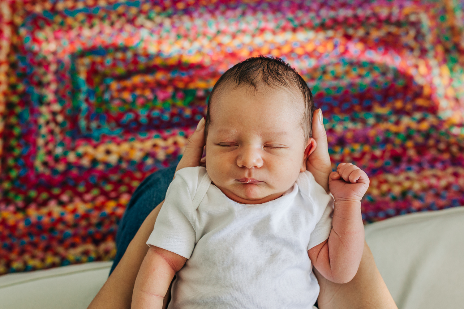 birds eye view of baby boy above a colorful carpet | Bay Area In-home Lifestyle Newborn Photographer