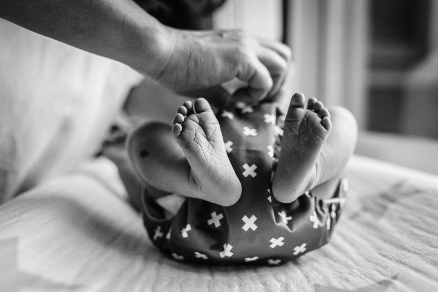 baby feet as mom changes the baby's diaper | San Francisco Newborn Photography