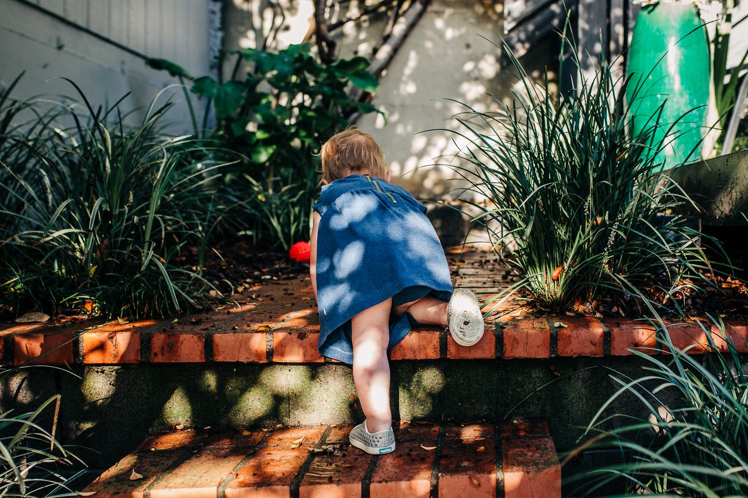 Toddler girl crawling up stairs outside | Bay Area Family Photography