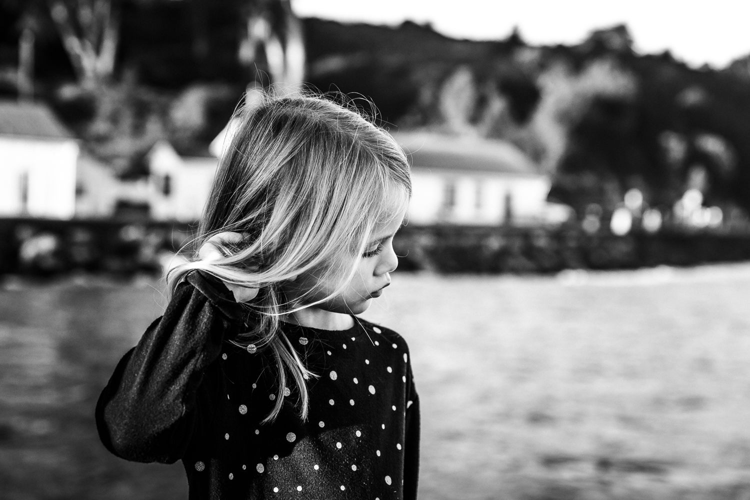 Black and white profile of a 6 year old girl playing with her hair | Bay Area Family Photographer
