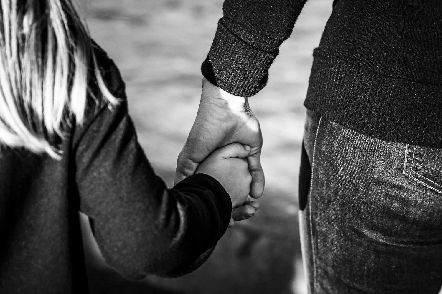 Black and white detail shot of a mom holding her 6 year old daughter's hand | SF Family Photographer
